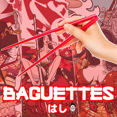 Une main tenant une paire de baguettes japonaise de couleur rouge