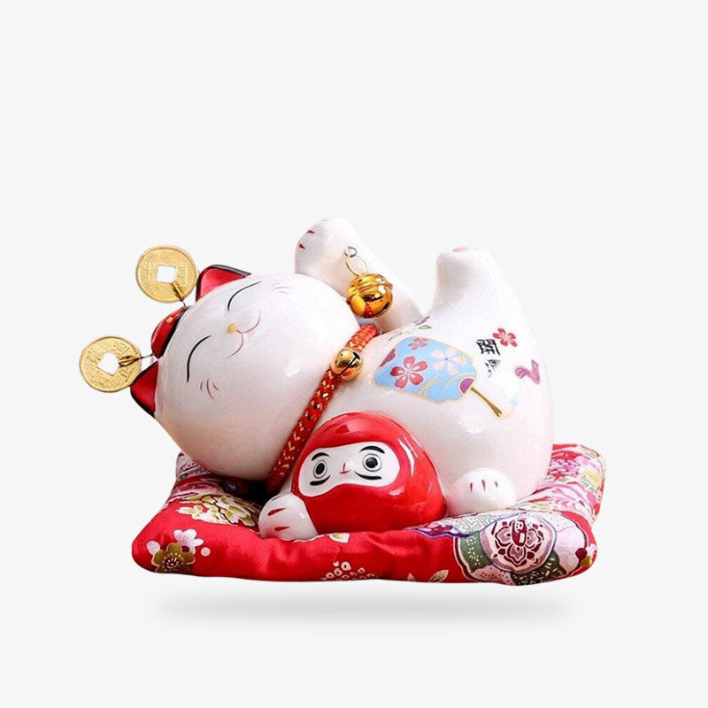 Ce chat japonais est un maneki neko ceramique. C'est un objet deco japonais. C'est aussi une tirelire pour les pièces. Il tien dans la patte une statuette Daruma