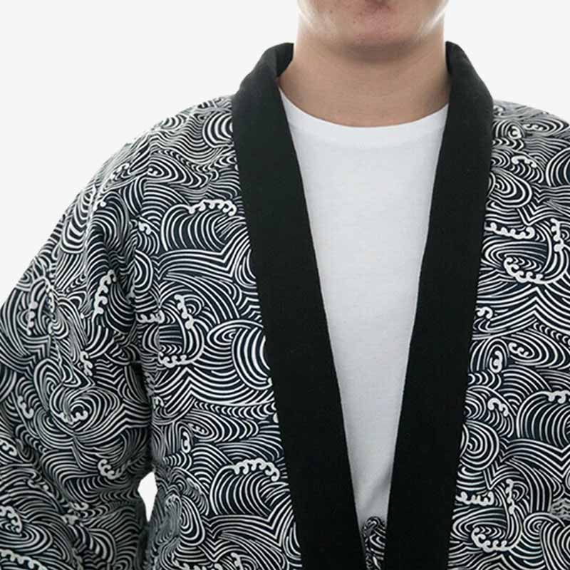 Un homme est habillé avec un manteau kimono nami par dessus un t-shirt blanc. La veste kimono est imprimé avec des motifs de vagues japonaise (nami) sur le tissus en coton